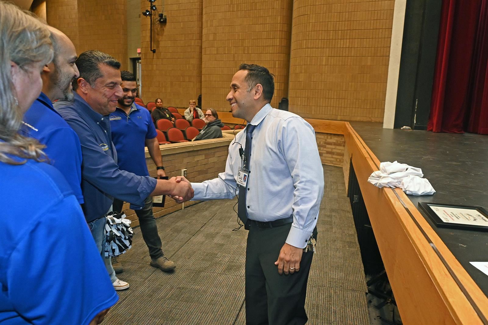 Dr. José Martinez, Langham Creek High School principal, shakes hands with Moufid Rabieh.